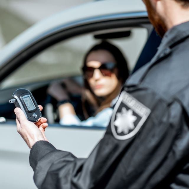 A police officer waiting for breathalyzer test result to come out