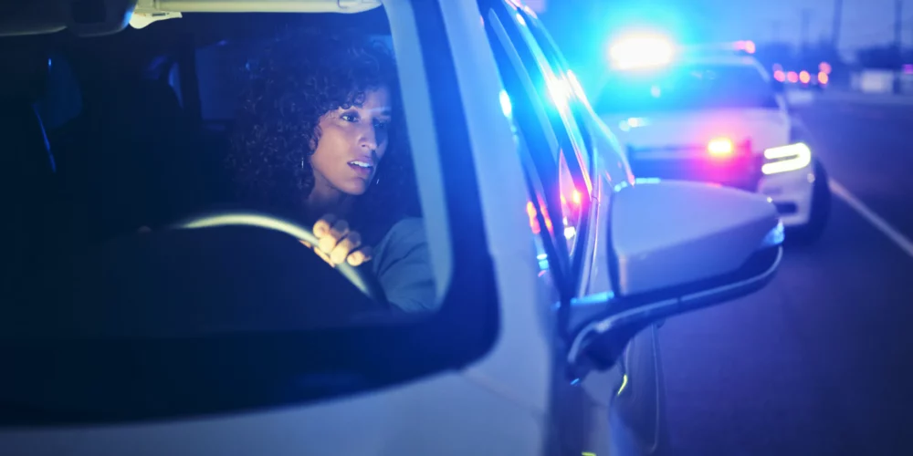 A female driver being pulled over by the cop